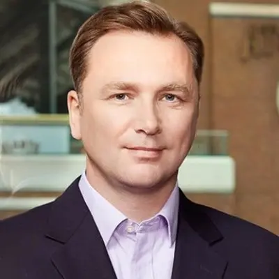 A man in a suit standing in front of a building specializing in Technical Recruiting Services.