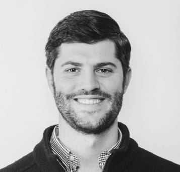 A black and white photo of a man smiling in the San Francisco Bay Area.