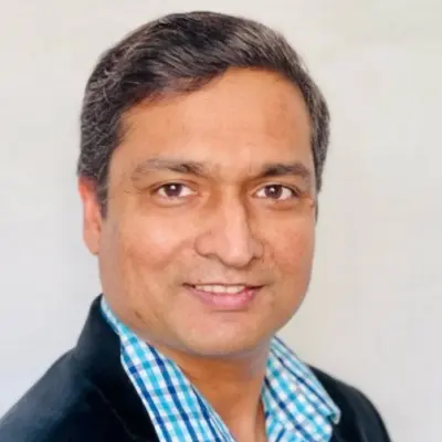 An Indian man in the San Francisco Bay Area smiling for the camera.