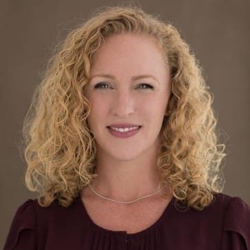 A woman with curly hair in a burgundy top offers Technical Recruiting Services in the San Francisco Bay Area.