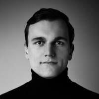 A black and white photo of a man in a turtle neck sweater, taken in the San Francisco Bay Area.