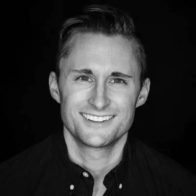 A black and white photo of a Technical Recruiting Services professional smiling in the San Francisco Bay Area.