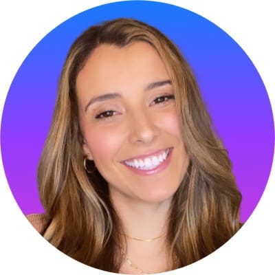 A woman smiling in front of a purple circle in the San Francisco Bay Area.