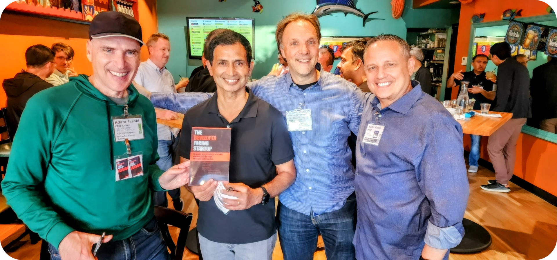 Group of men holding a book in a restaurant.