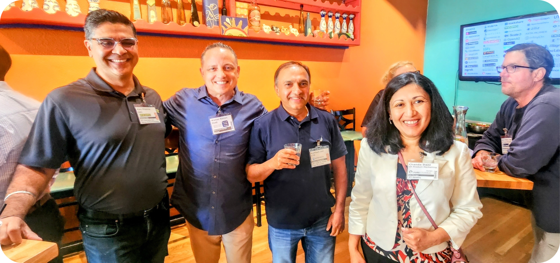 Four people smiling at a networking event.