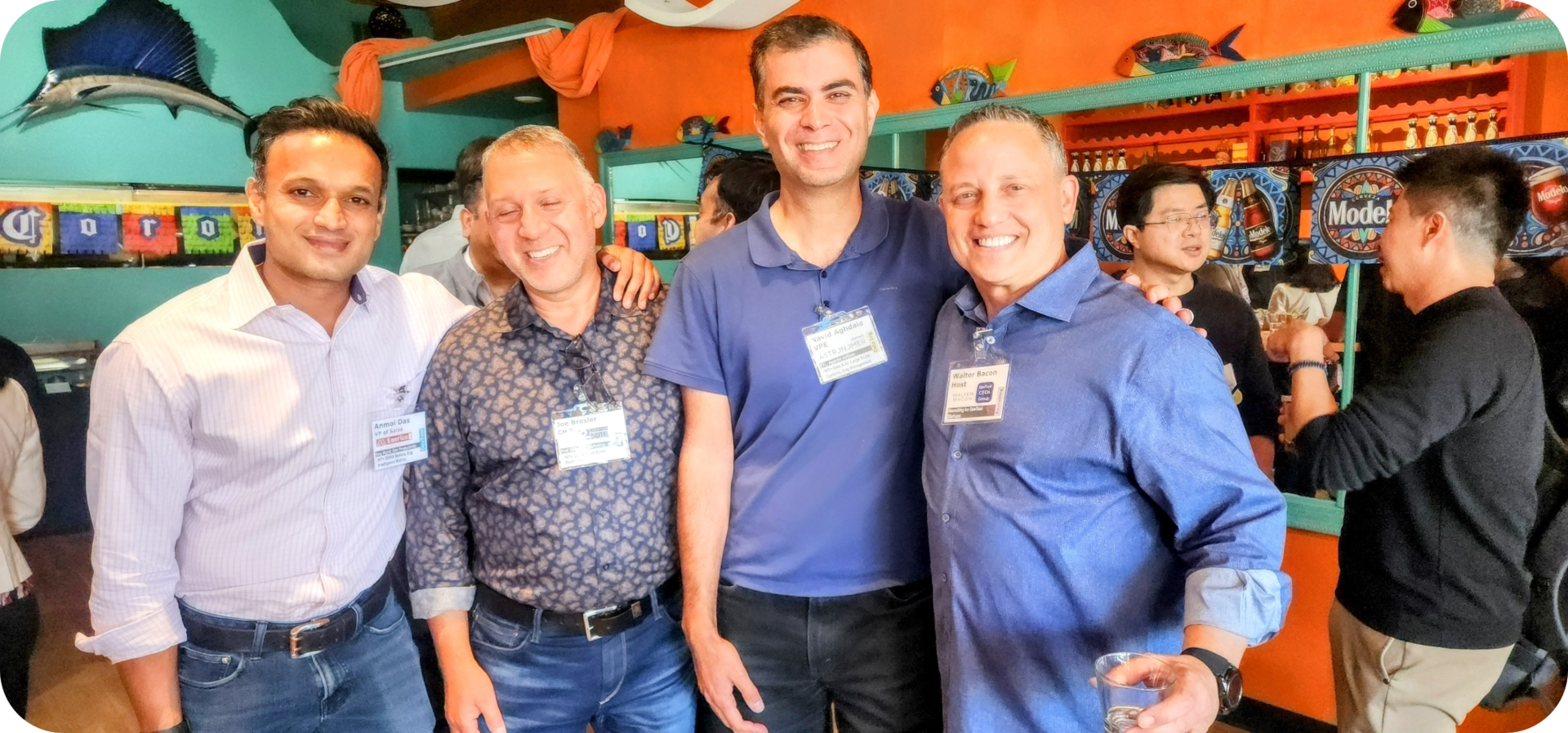 Four men smiling for a group photo.