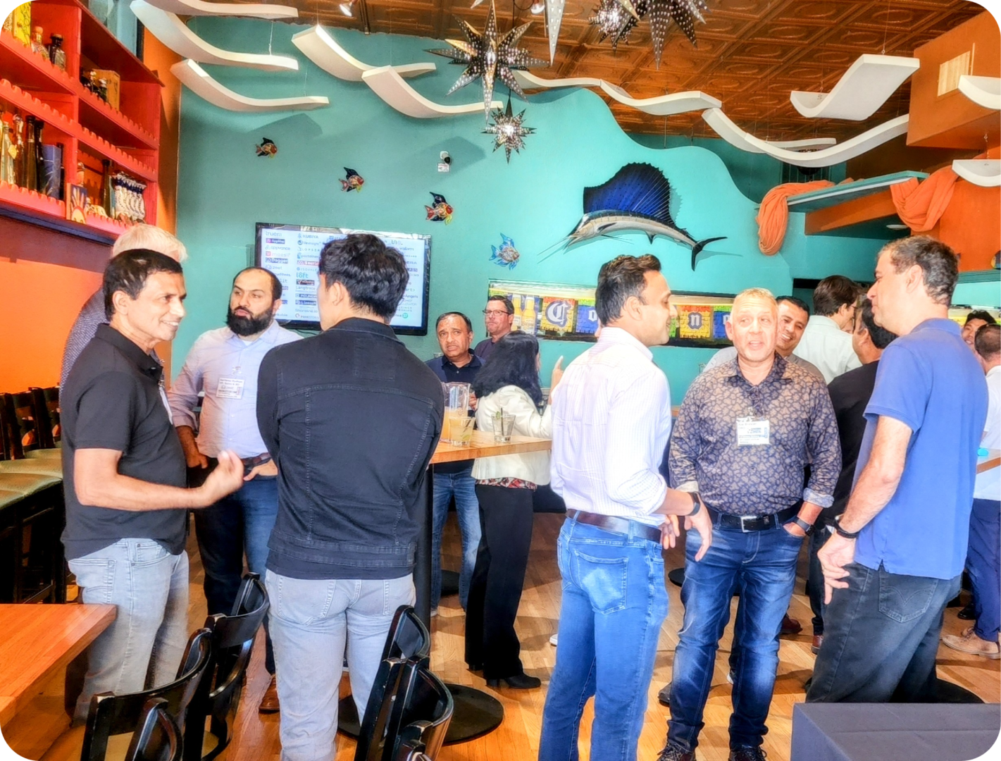 Group of men socializing in a restaurant.